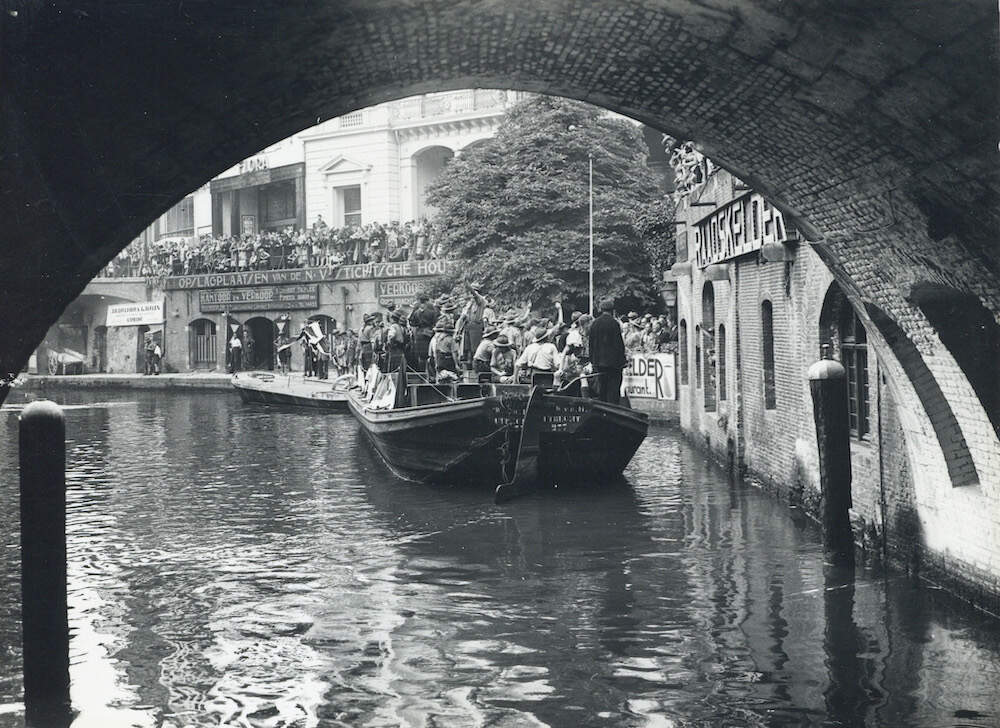 Groep buitenlandse padvinders die na het sluiten van de Wereldjamboree te Vogelenzang een bezoek bracht aan Utrecht op een dekschuit in de Oudegracht Lauwers 1937 HUA